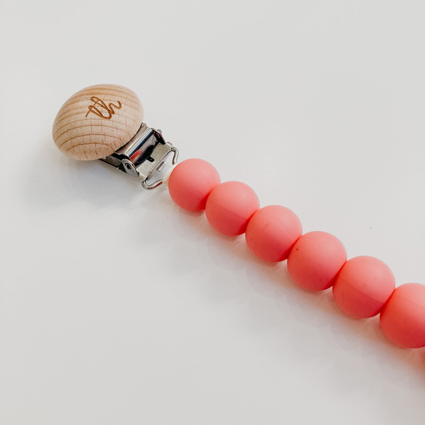 jolie pacifier clip in baby pink close up
